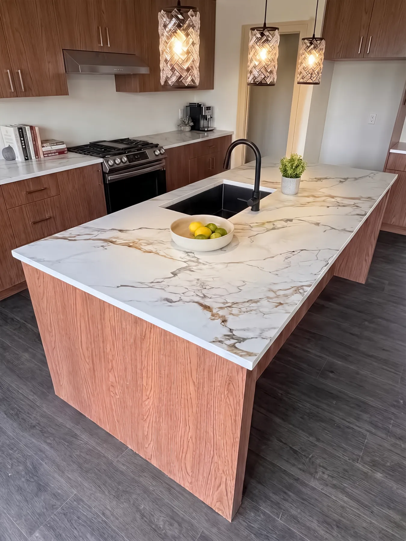 Black undermount sink and matte black tap set into the island